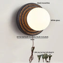 Axyaa White Glass Ball LED Wall Sconce Black Travertine Light Fixture